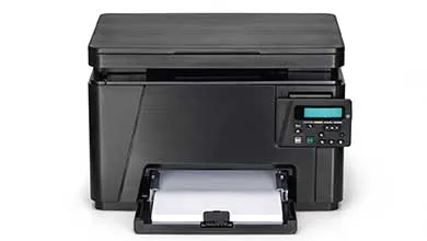 Front view of a black multi-function printer with a top scanner lid, a control panel with a small screen, and a bottom paper tray loaded with paper, set against a white background.