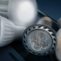 Close-up of assorted LED light bulbs on a dark blue background, highlighting a silver-rimmed spotlight with four visible LED chips in front and white bulbs with clusters of small yellow-orange diodes to the right, with the AVIENT logo in the bottom corner.