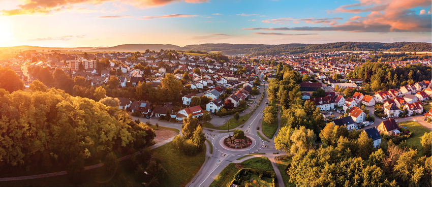 Aerial panorama of a European town at sunrise, with magnificent colorful sky and warm light